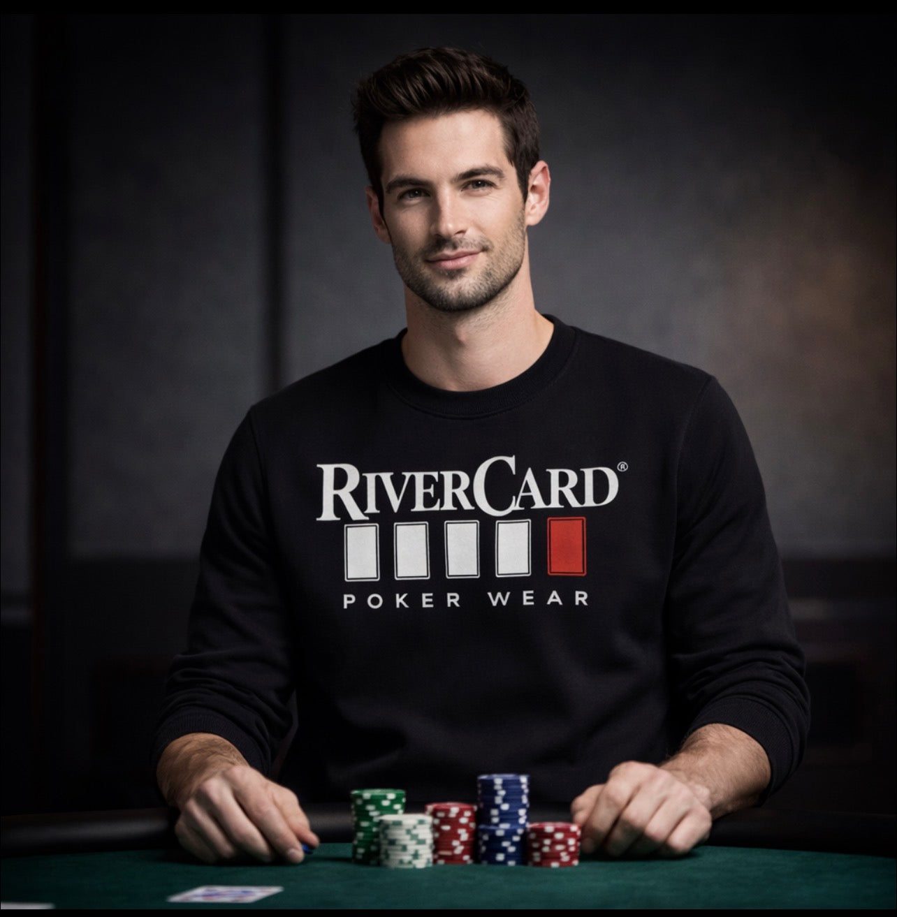 Man wearing black RiverCard Poker Wear sweatshirt at a poker table